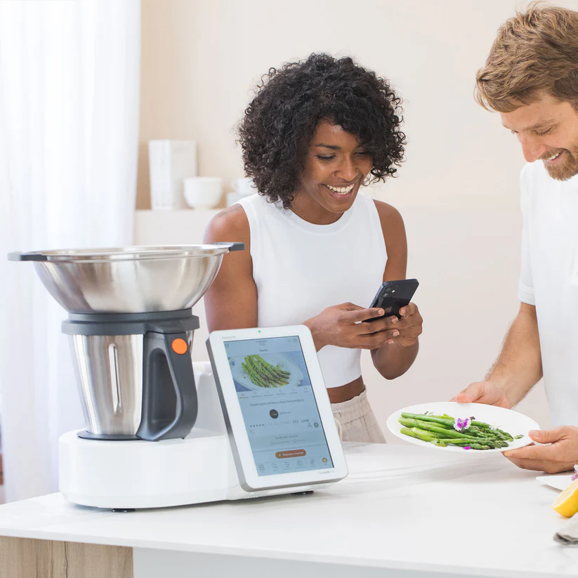 Familia española cocinando junta con robot inteligente